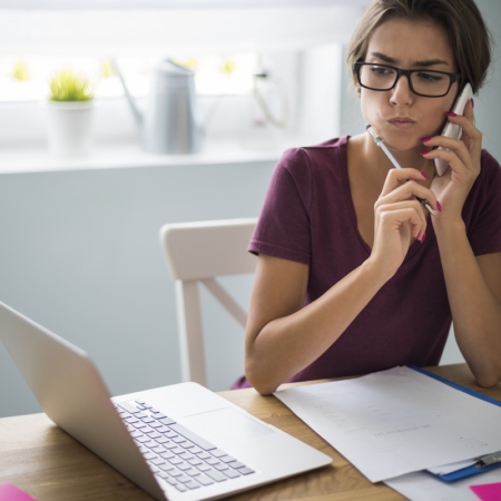 Travailleuse indépendante réfléchissant à sa protection santé au bureau
